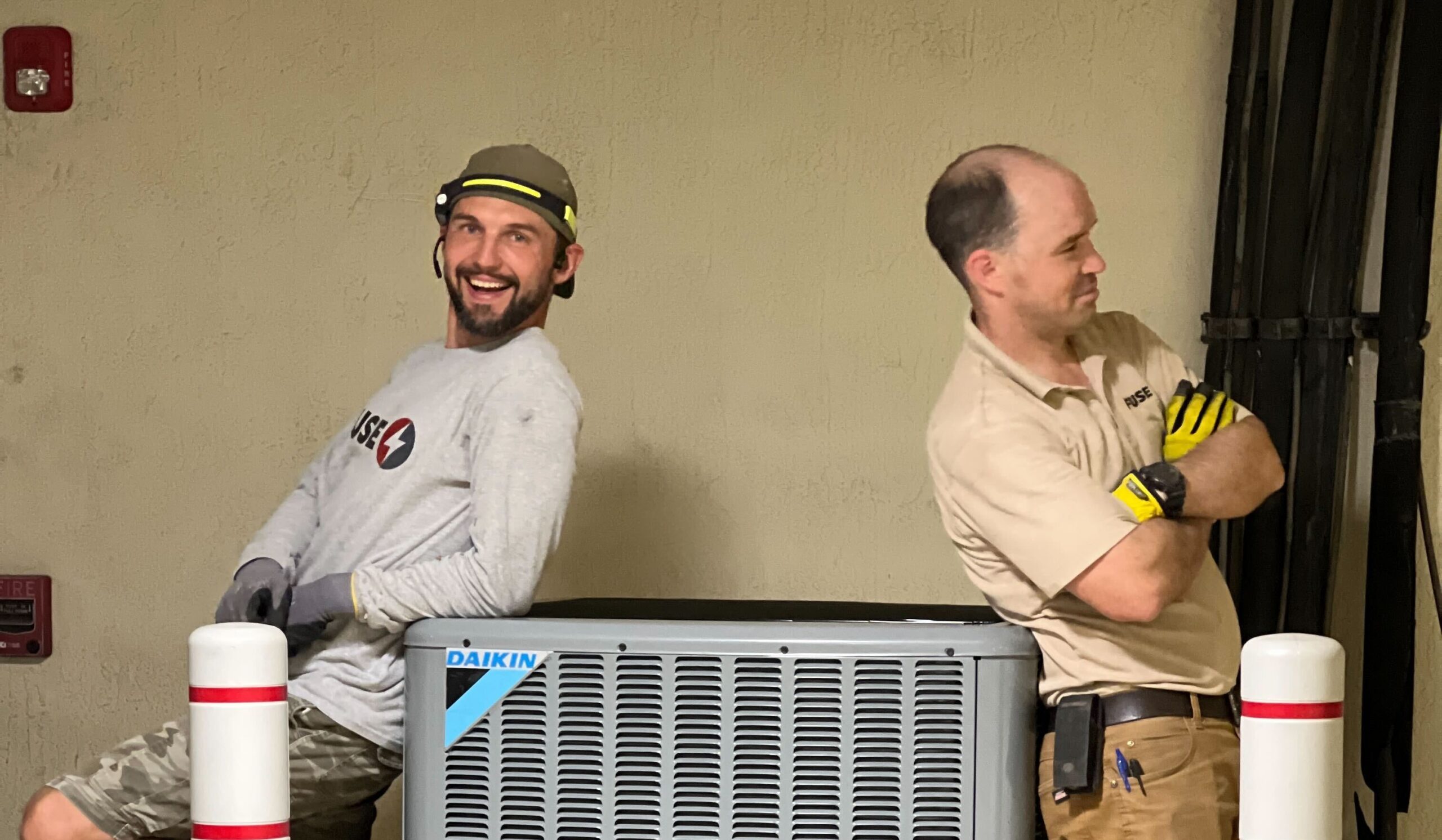 Fuse Technicians beside the HVAC