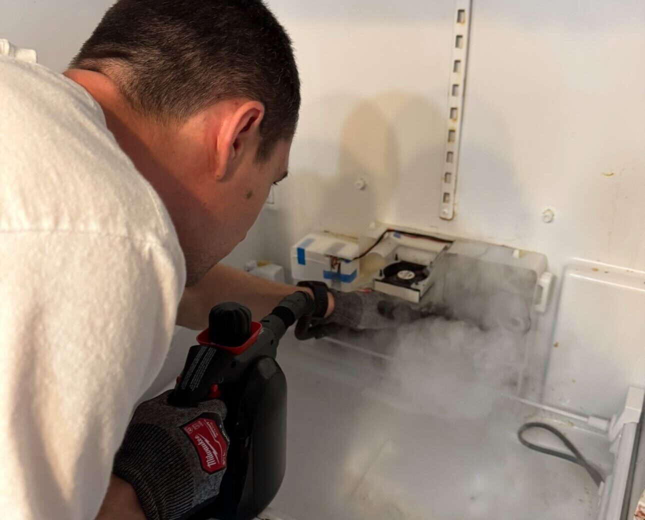 a person fixing the appliance