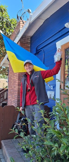 appliance repair del monte forest ca: Technician standing by the house with a flag