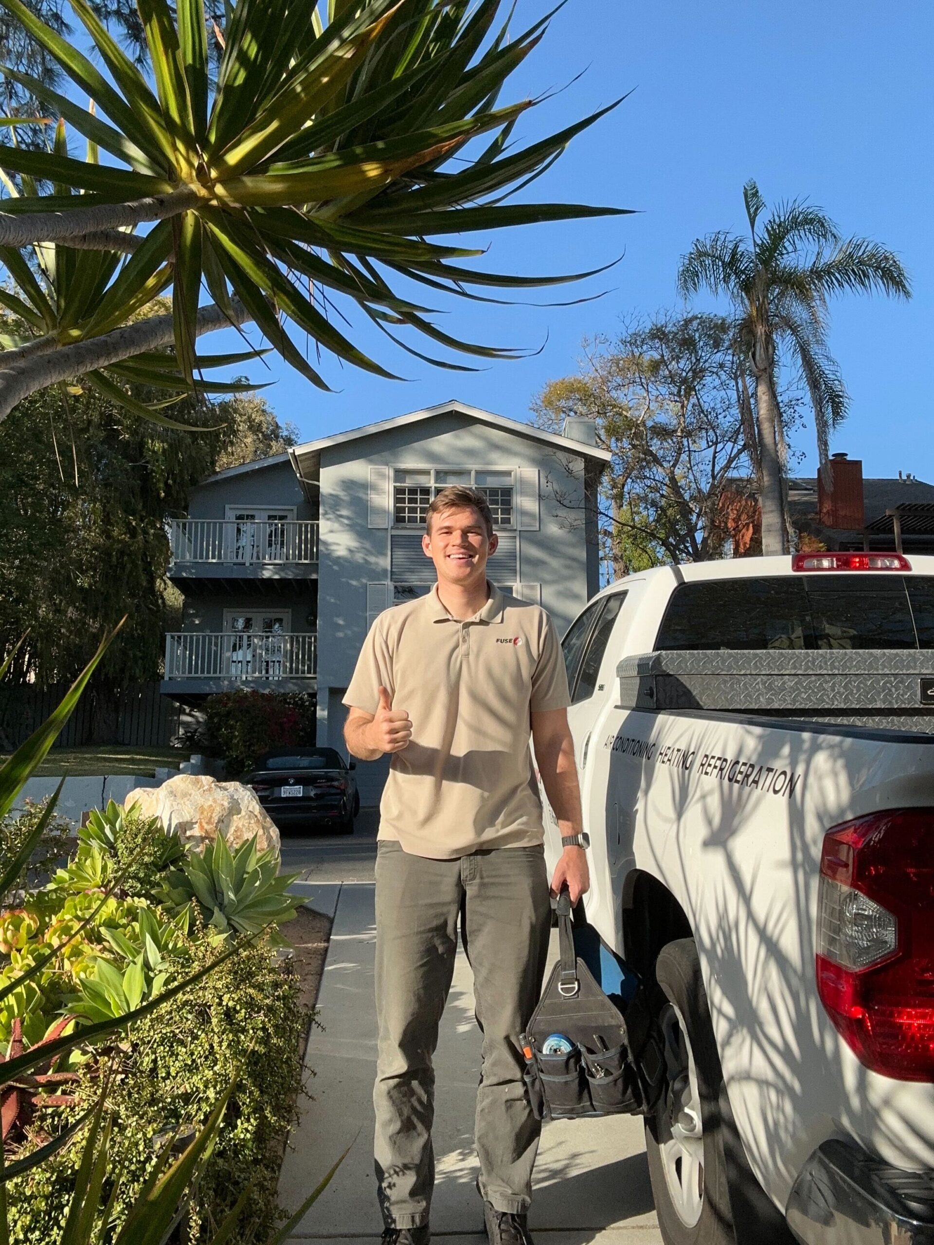 electrician carmel valley standing next to client's house
