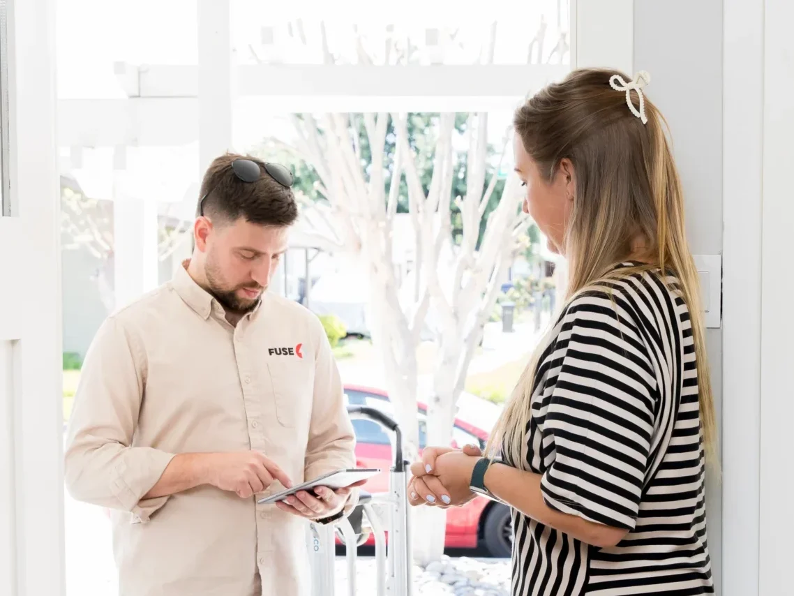 technician discussing with a client about water heater repair salinas