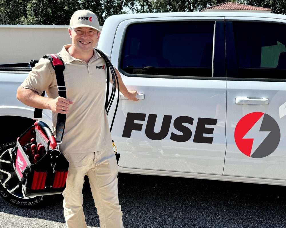 technician standing next to fuse car