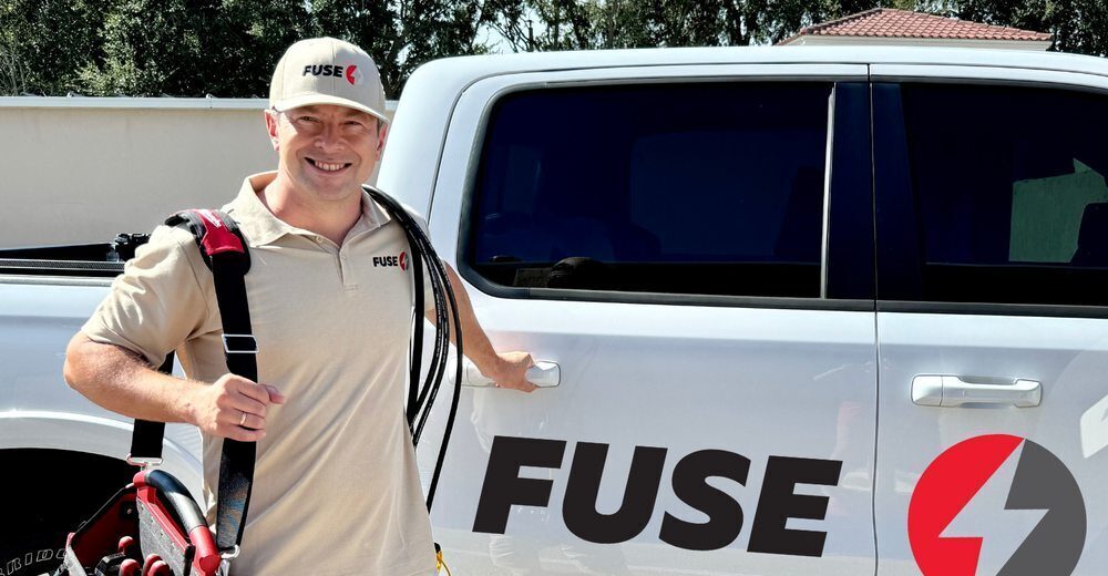 technician standing next to fuse car